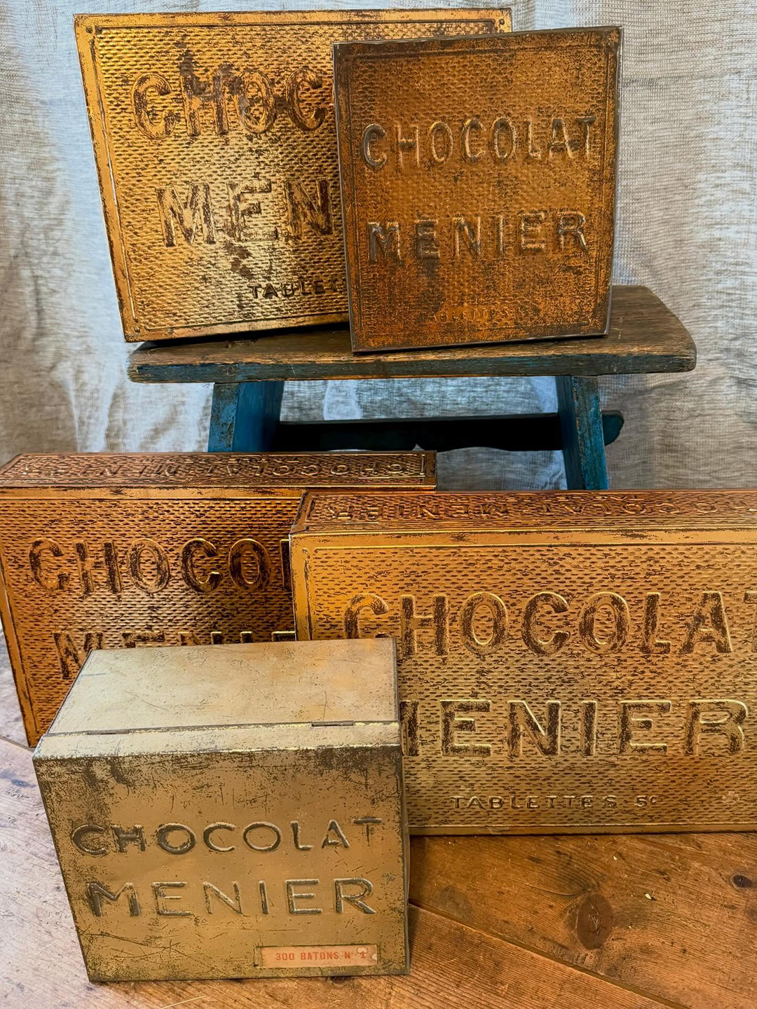 gold boxes with engraved words on them