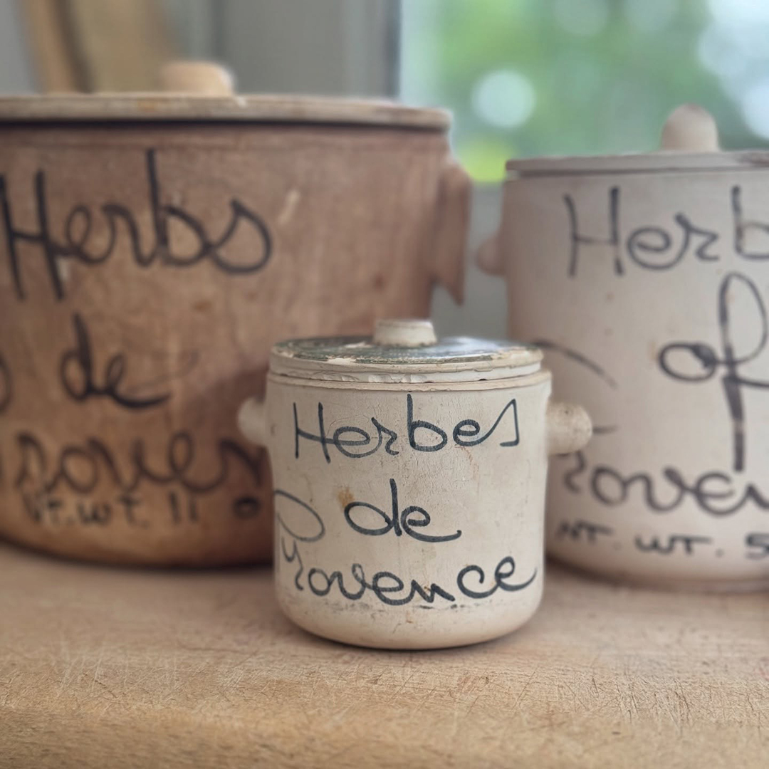 3 clay pots with lids and "herbs de Provence" in script on the side