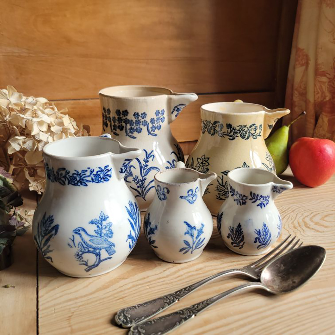 group of blue-and-white ceramic pitchers