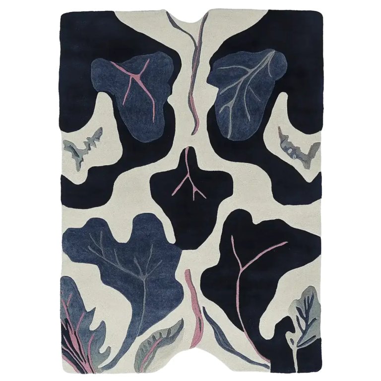 Cream rug with black and blue oversized leaf pattern.
