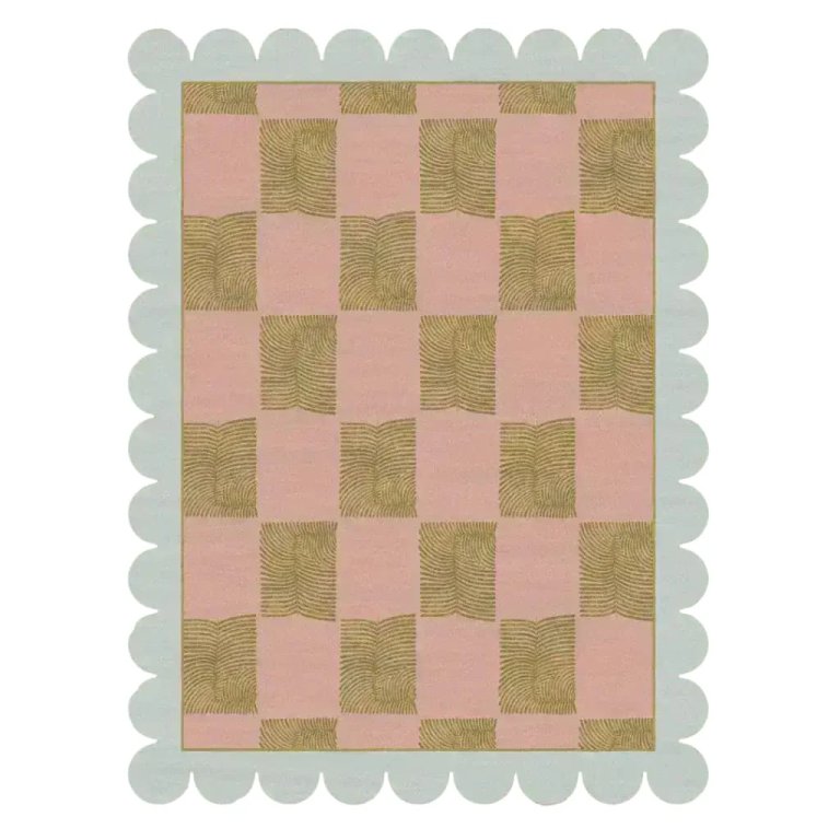 Pink and olive green checkerboard rug with scalloped edge.