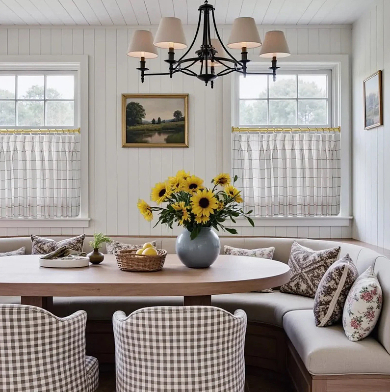 Kitchen dining nook with brown and white gingham chairs and matching cafe curtains.