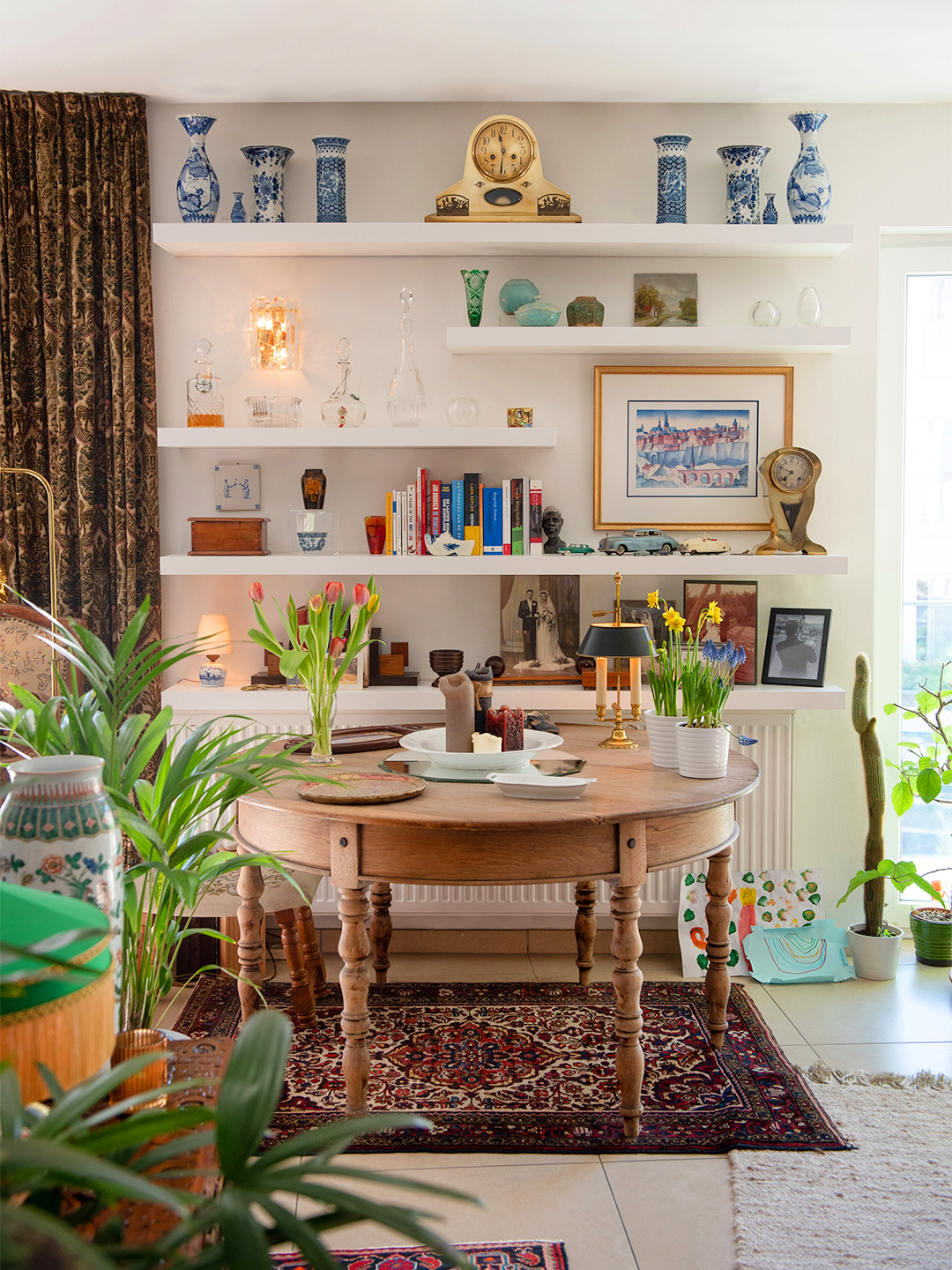 room with styled open shelves and dining table