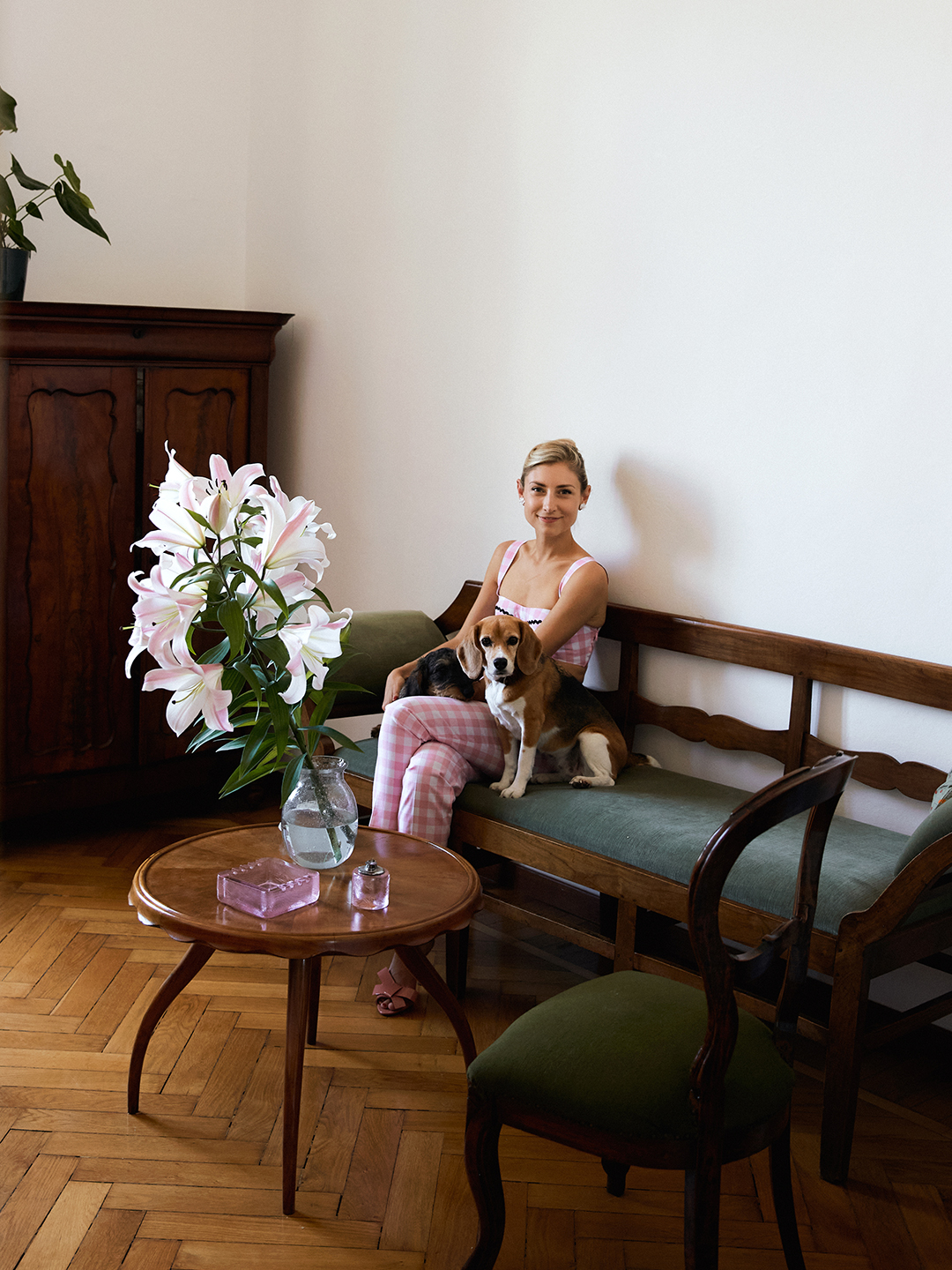 woman sitting on a wooden bench inside