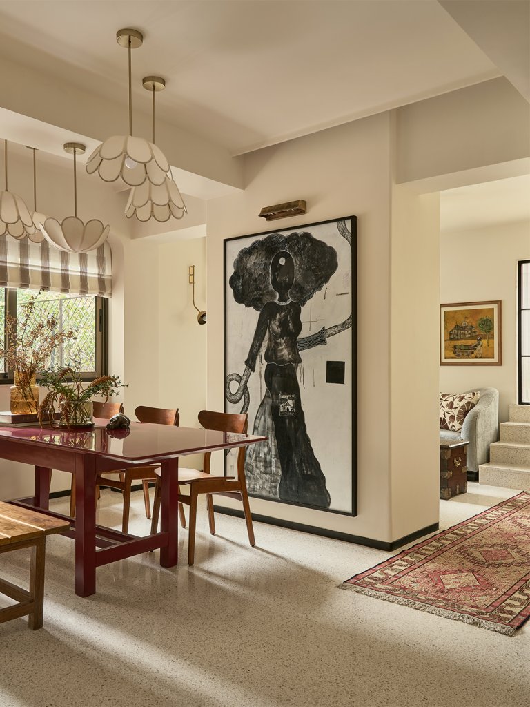 large artwork in dining room with red table