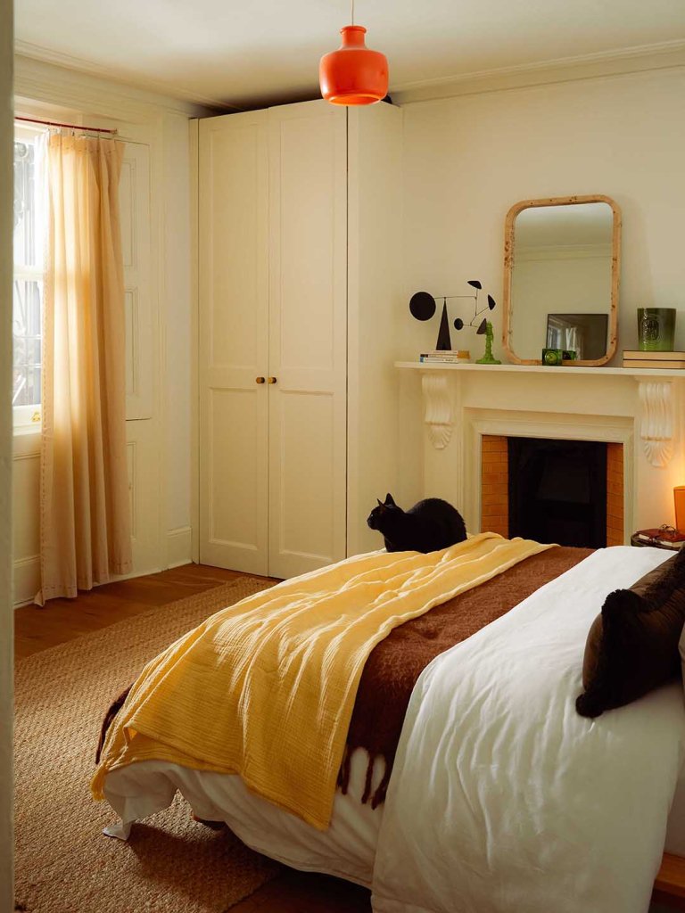 bedroom with fireplace and large window