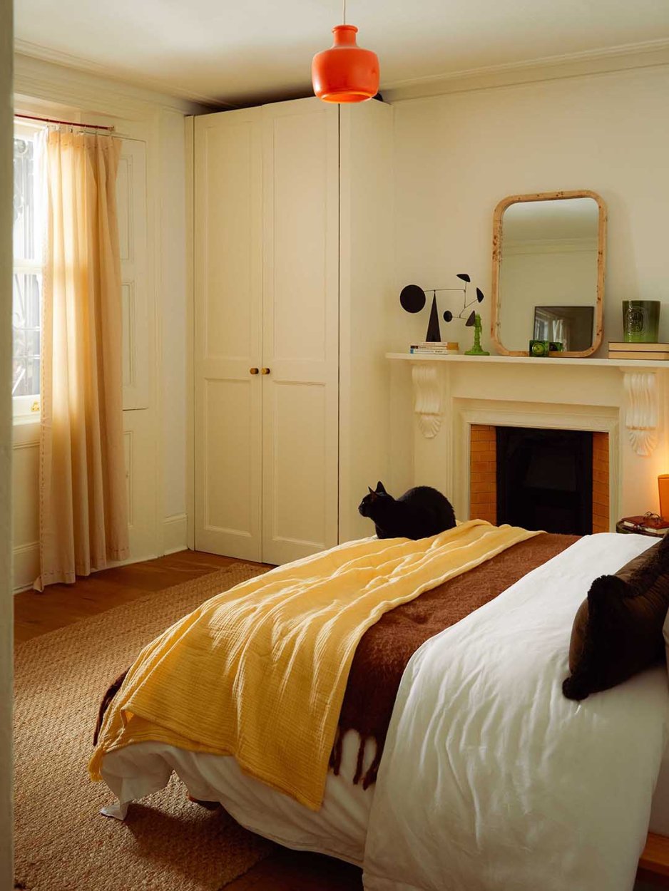 bedroom with fireplace and large window