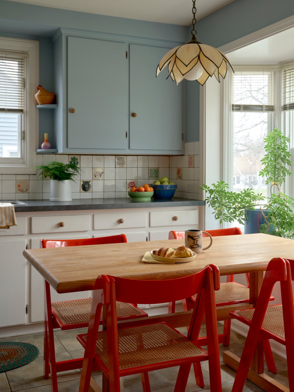 kitchen with blue cabinets and red chairs