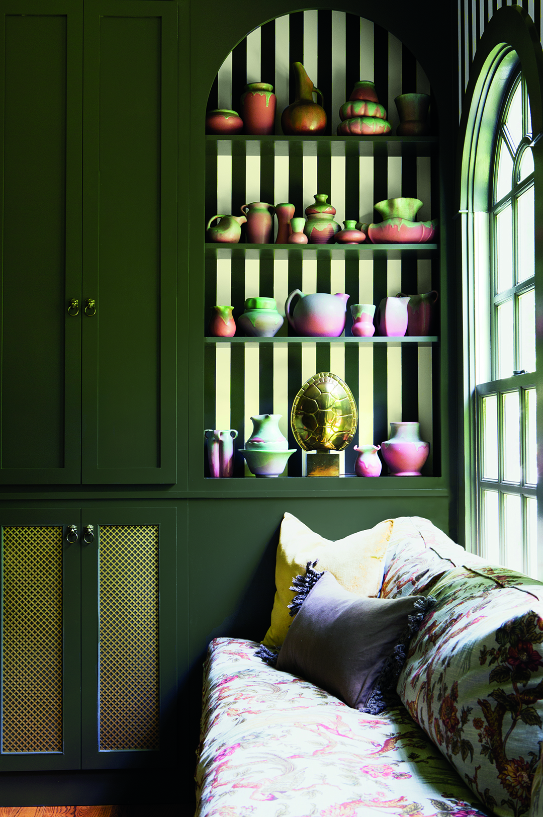 green wall with arched shelf and striped background
