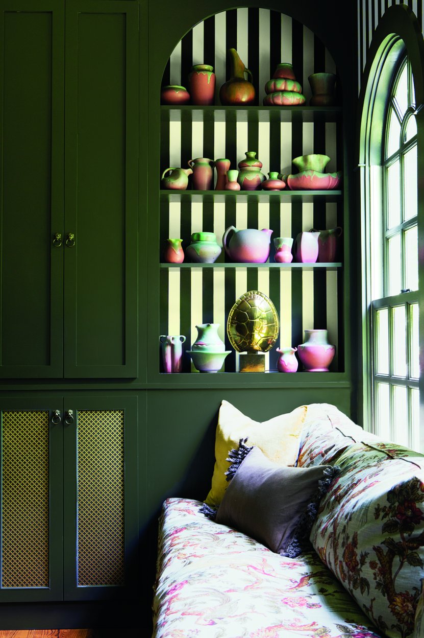 green wall with arched shelf and striped background