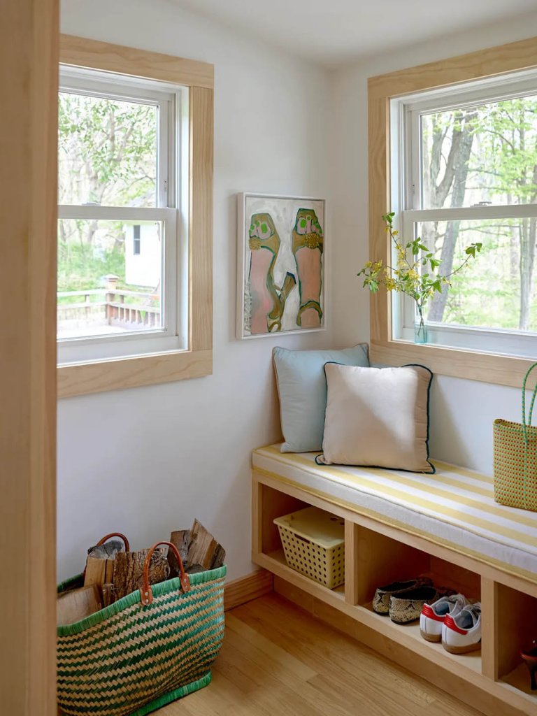 mudroom with bench and basket of firewood