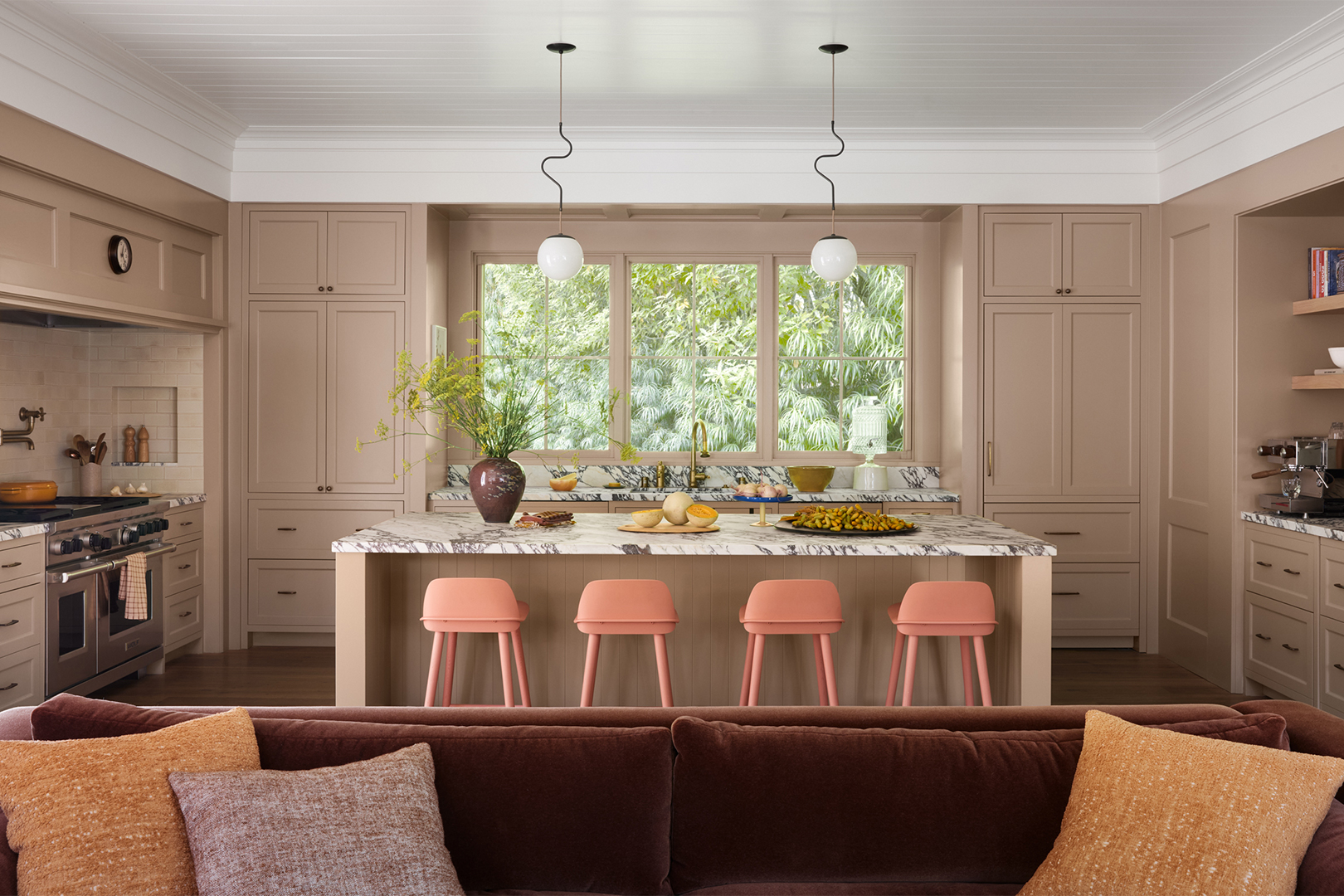 kitchen with wallpaper and pink stools