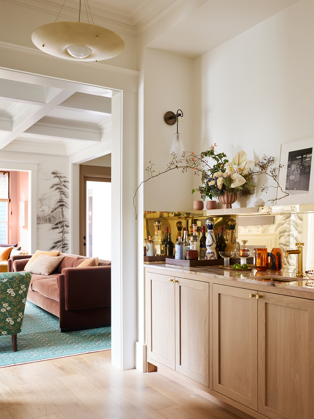 home bar with brass backsplash