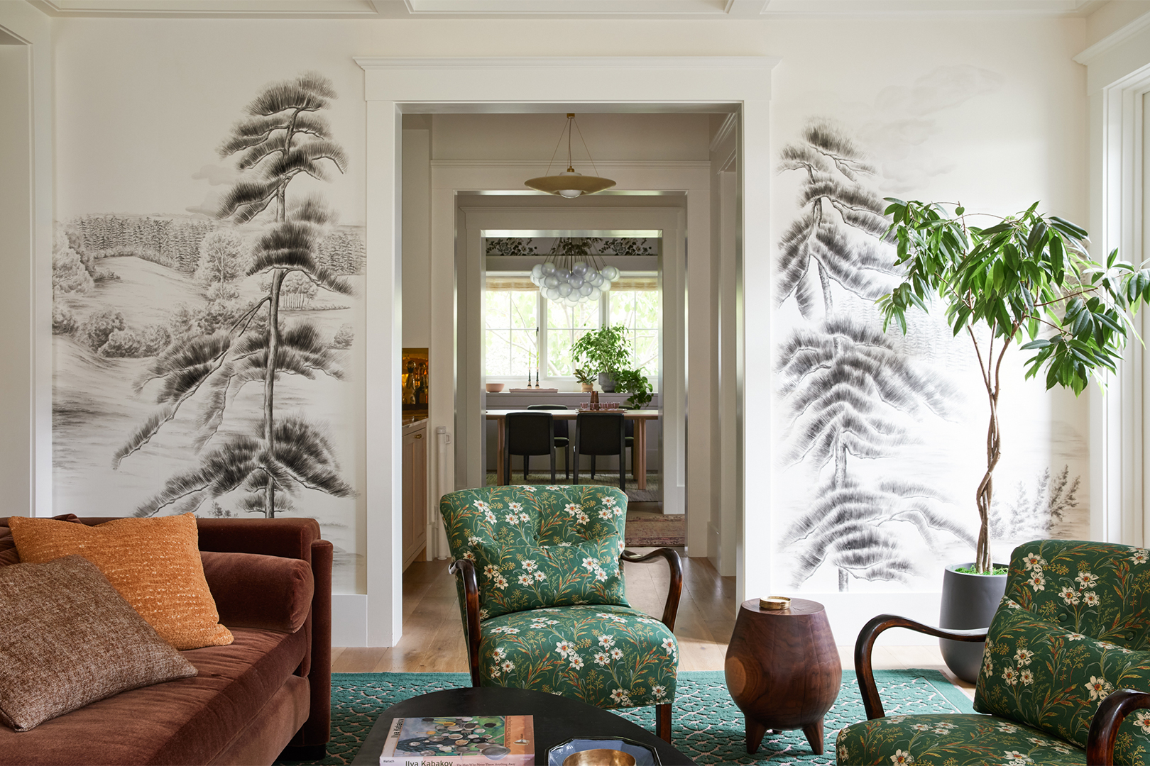 living room with painted branches on the walls