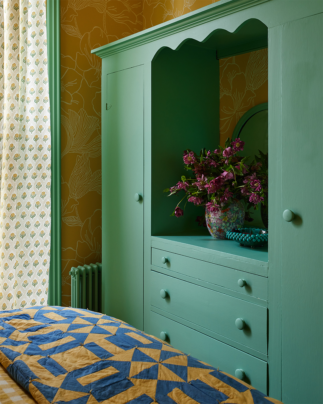 teal cabinet in bedroom
