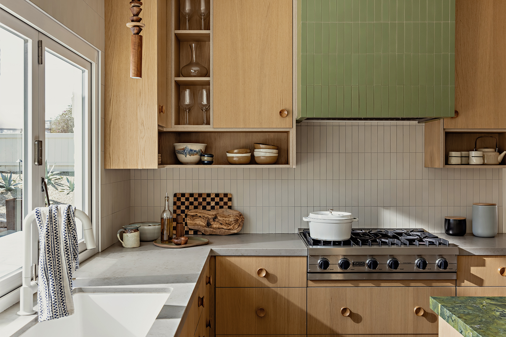 kitchen with wood cabinets and sage green accents