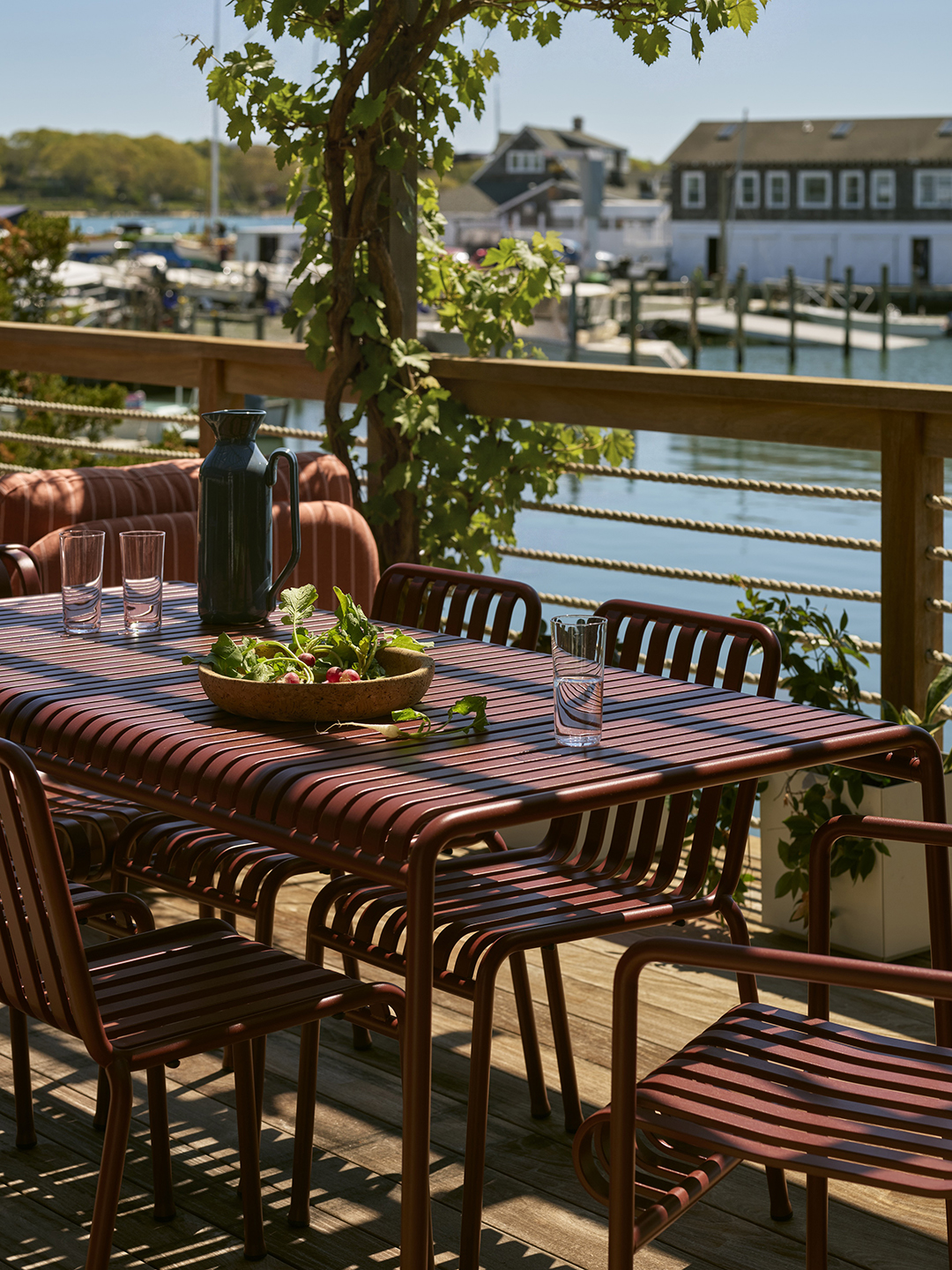 burgundy metal outdoor dining set on deck