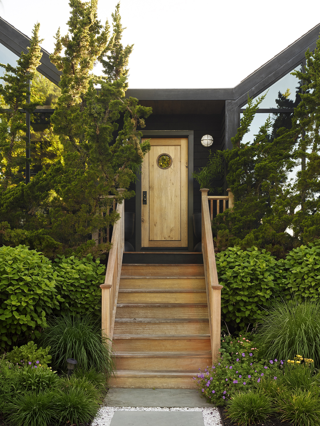 natural wood front door with porthole
