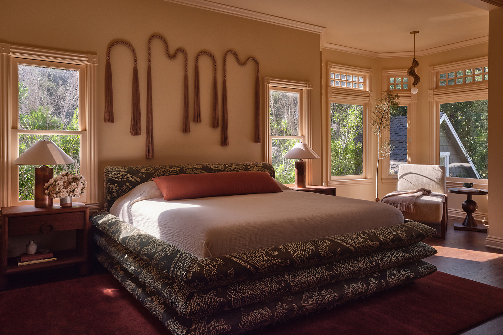 bedroom with upholstered bed and wallhangings