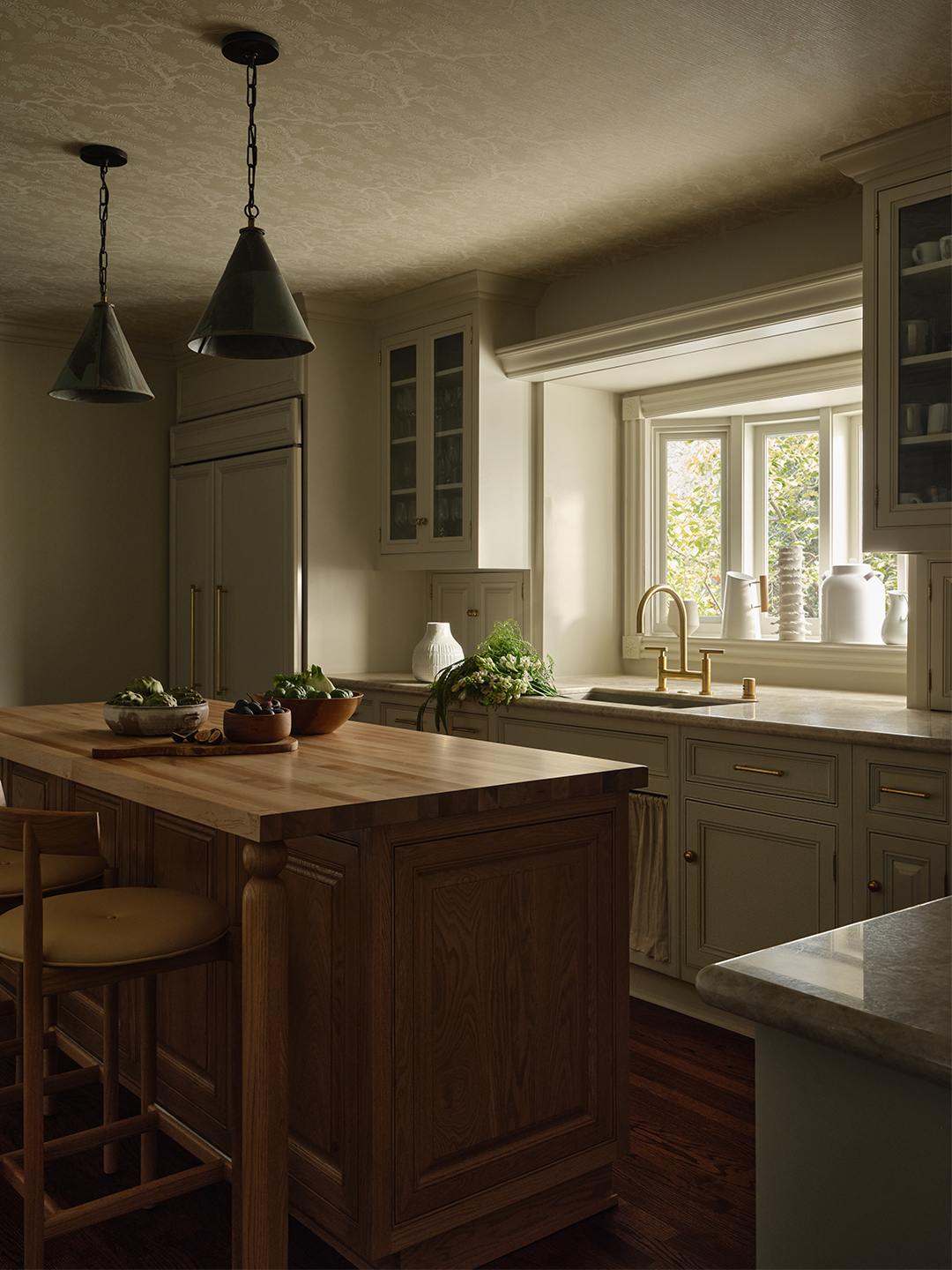 kitchen with white cabinets and wood island