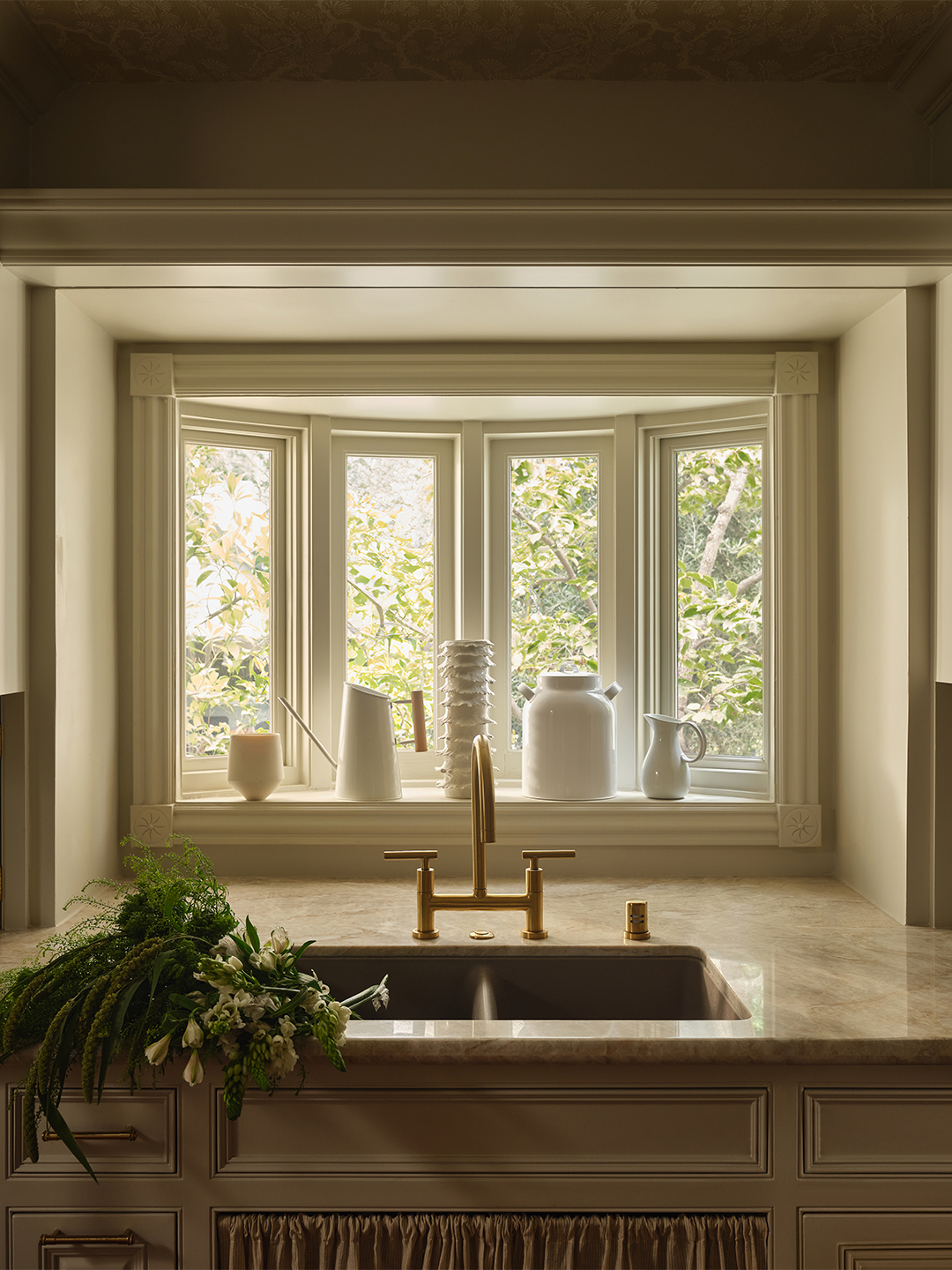 white kitchen with view out of window above the sink