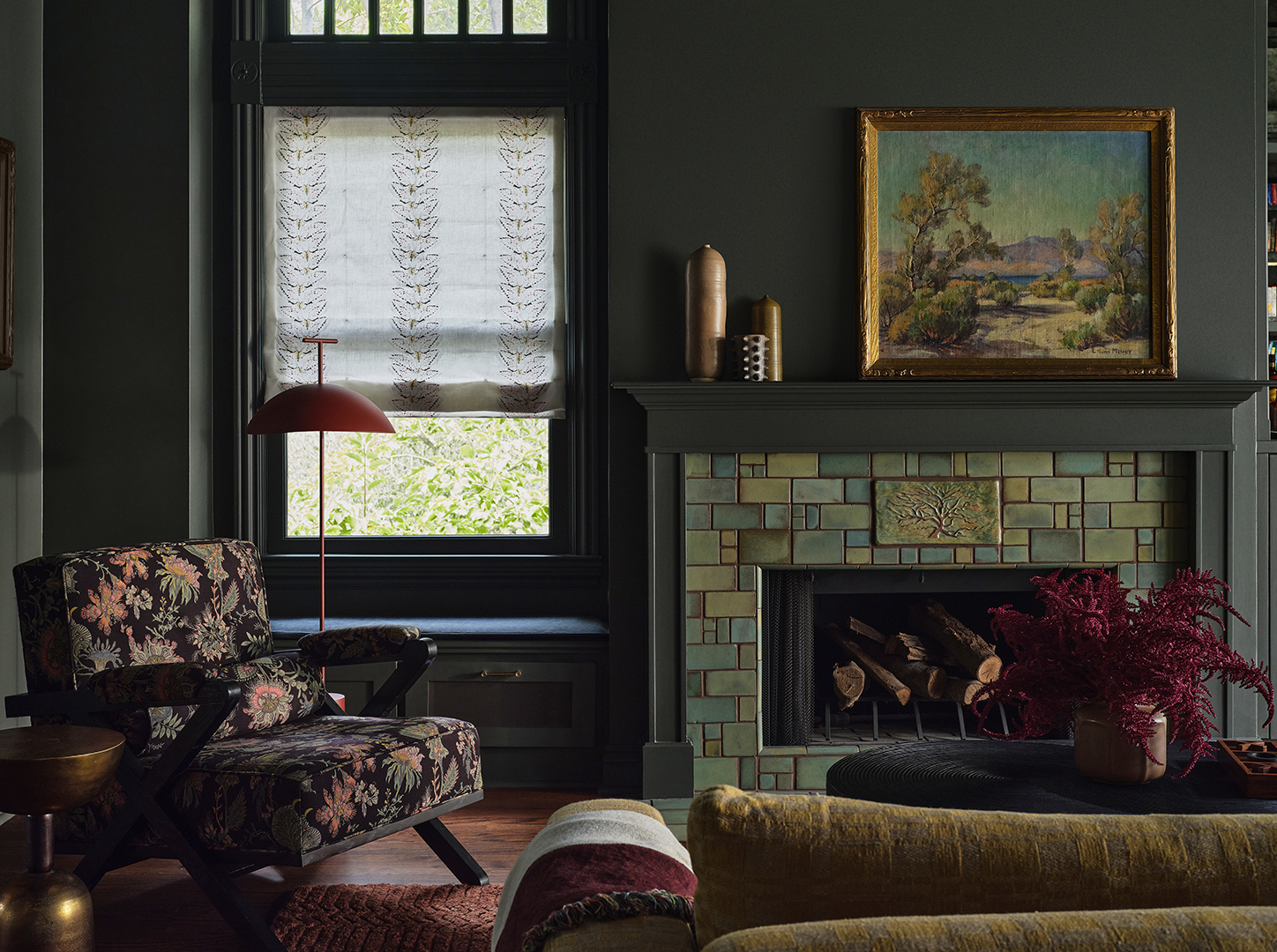 living room with floral chair and tiled fireplace