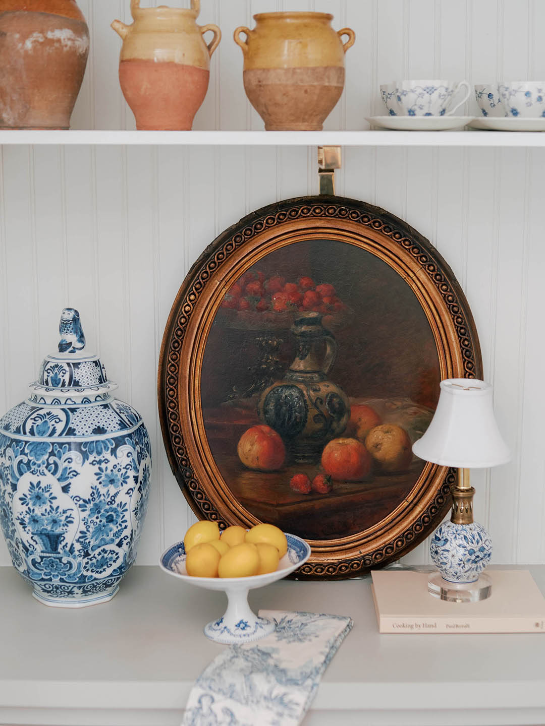 painting, vase, and ceramics on a shelf