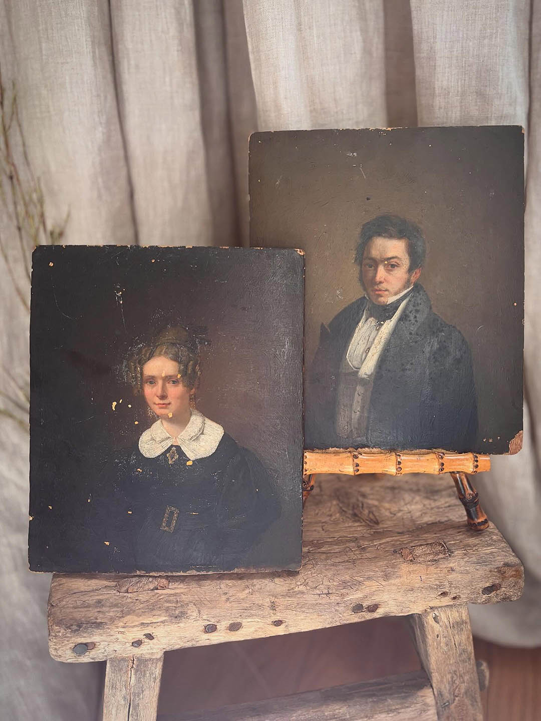 two portraits on a table on easels
