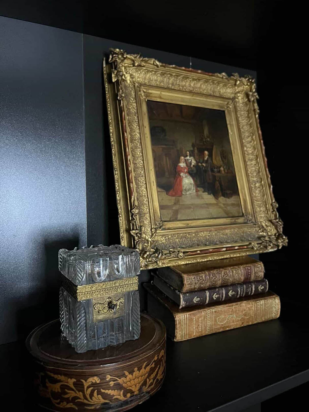 vignette of books and framed art on a shelf
