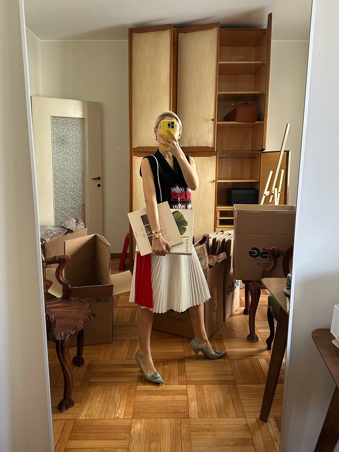 woman posing in a half-decorated apartment with boxes
