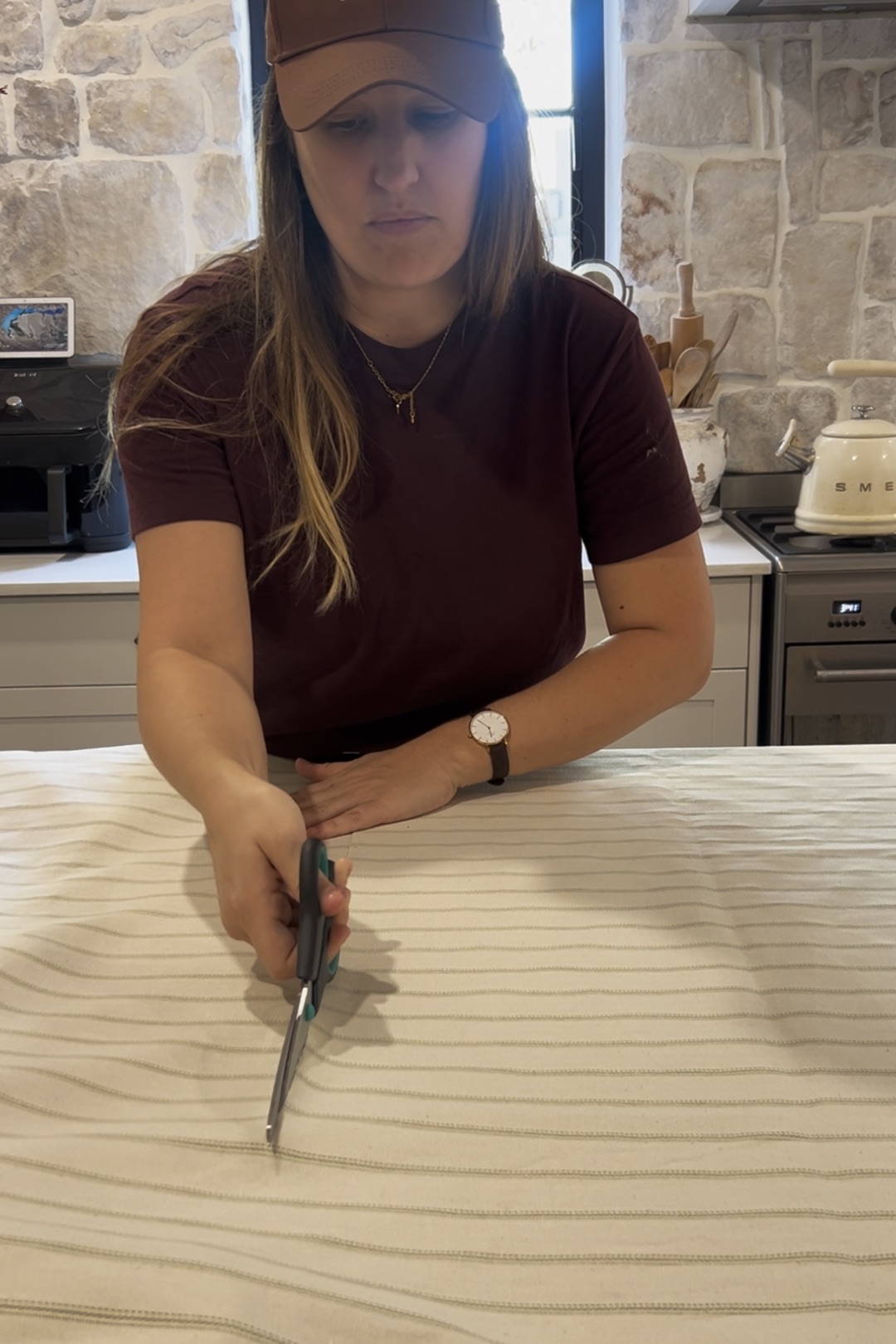 woman cutting striped fabric