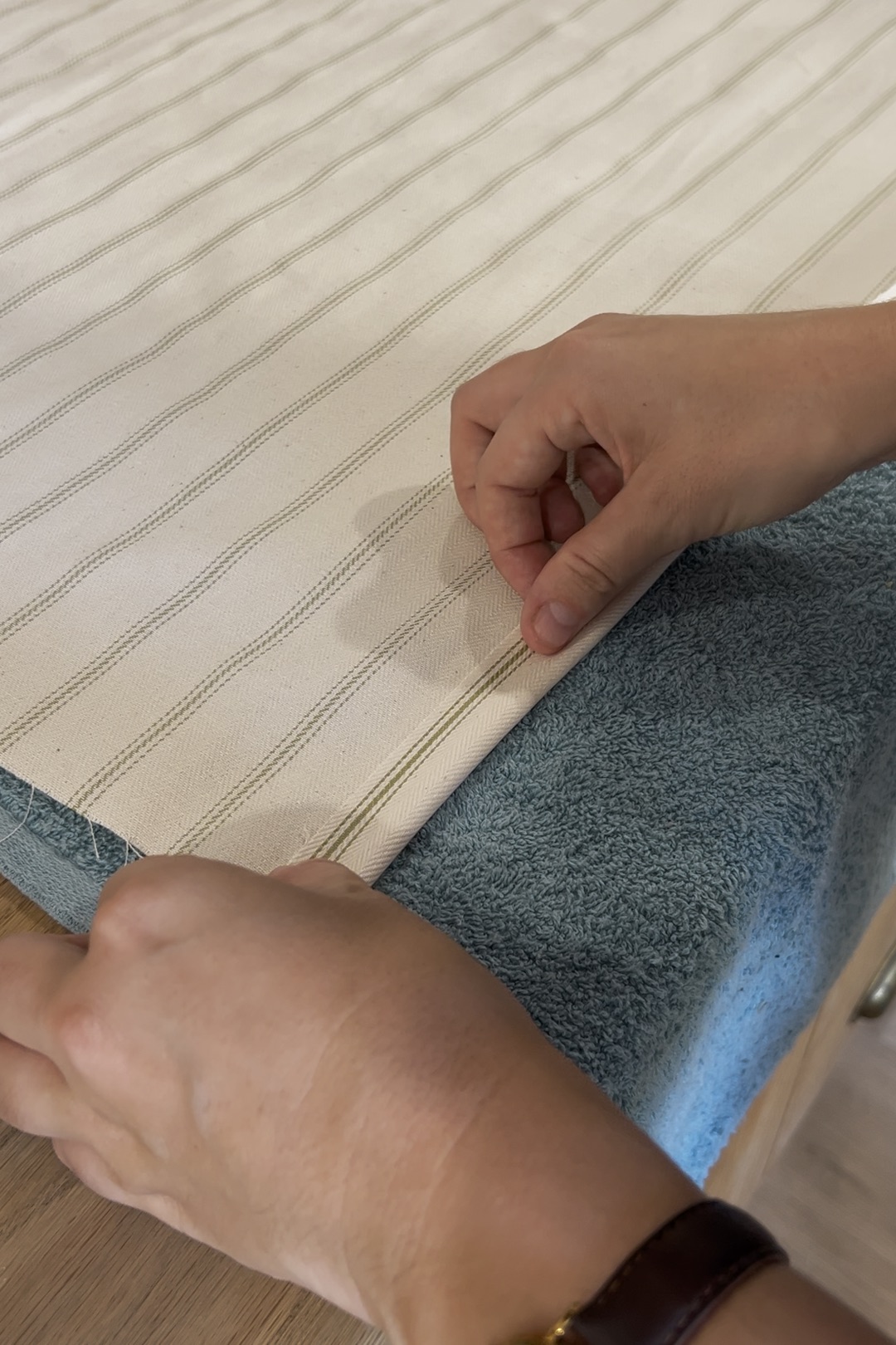 woman folding fabric over