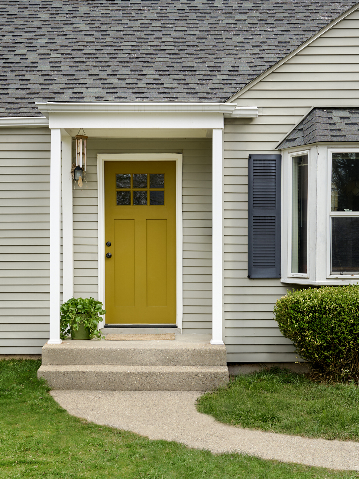 front of house with. yellow door