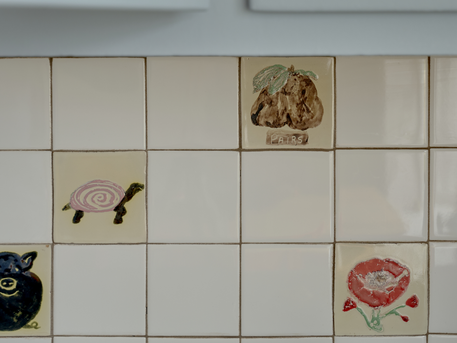 detail shot of tile backsplash with custom tiles