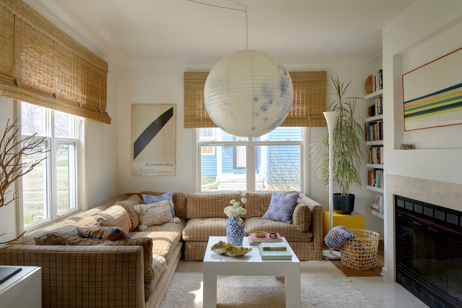 living room with paper lantern and gold sectional
