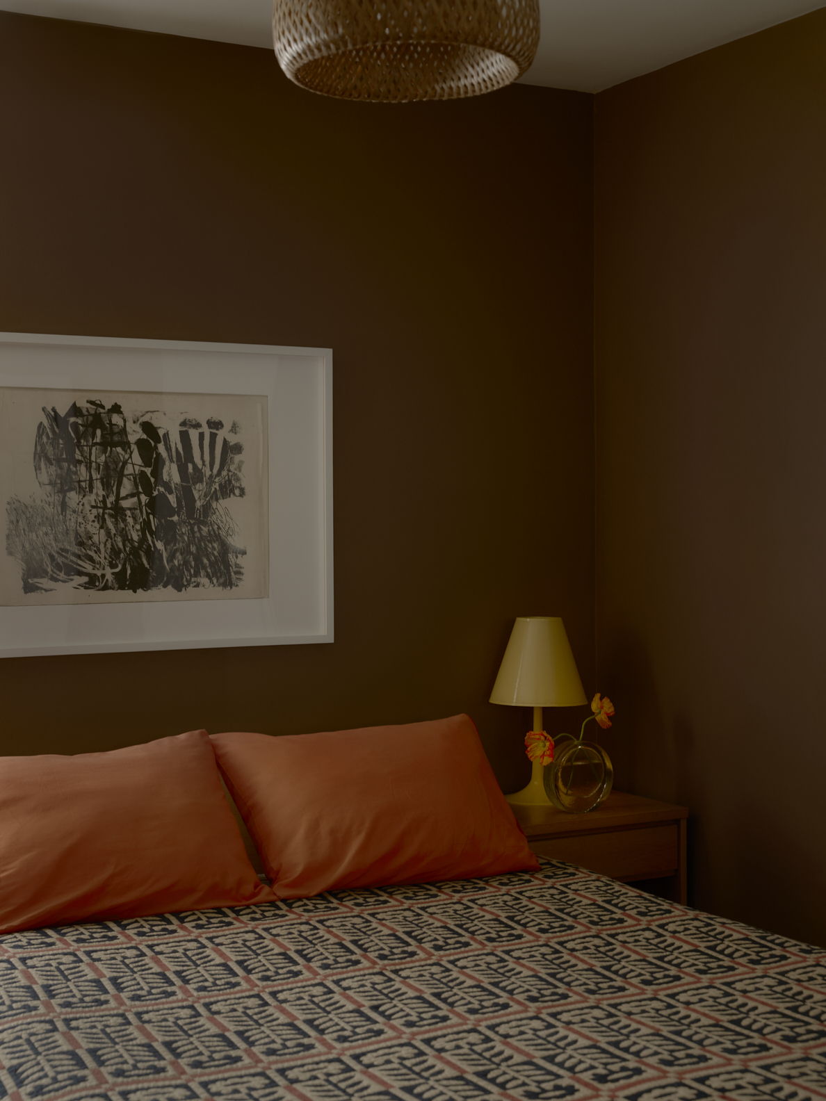 brown bedroom with art above bed