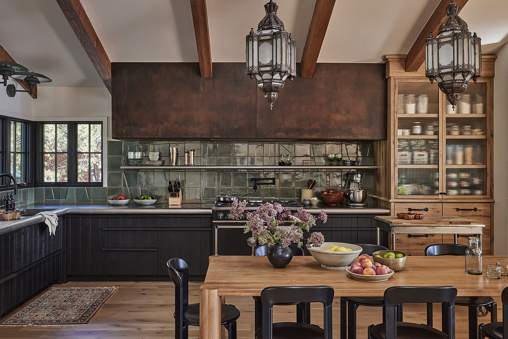 kitchen with large hood and tiled backsplash