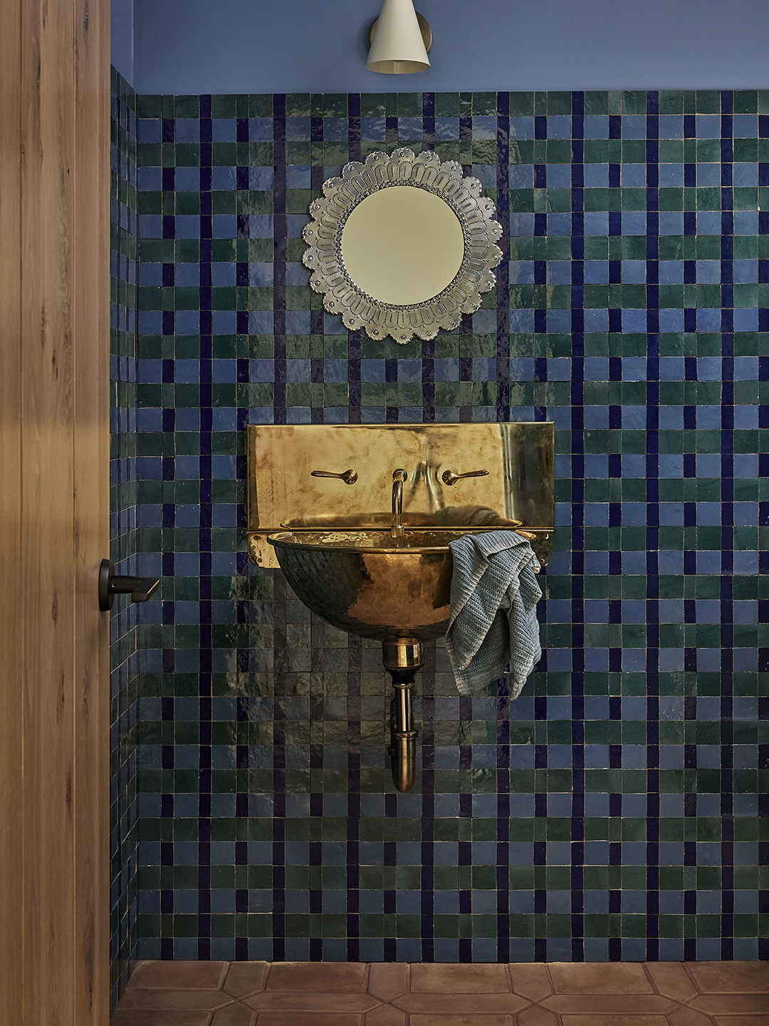 tiled bathroom with golden sink