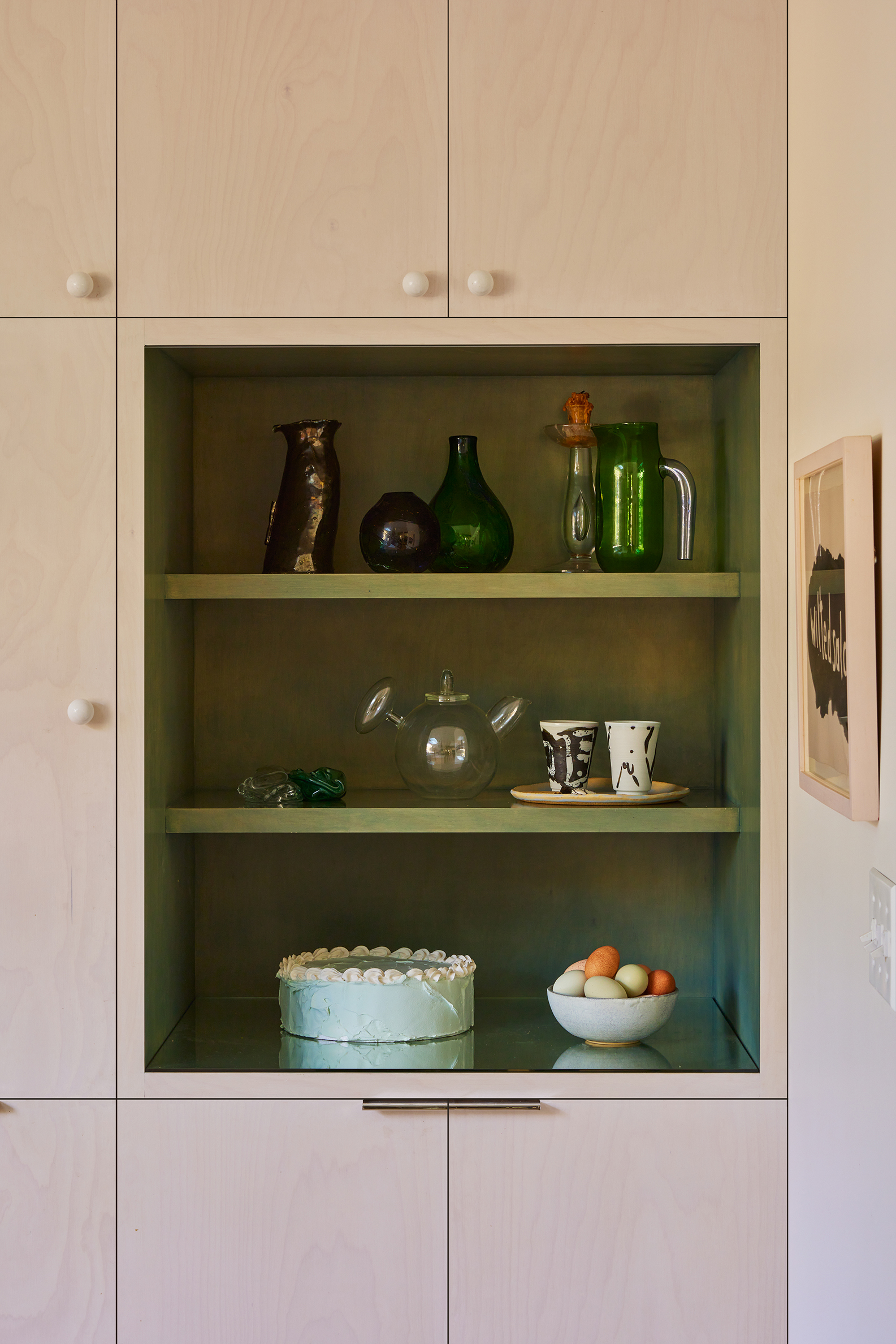 green shelves within wood cabinetry