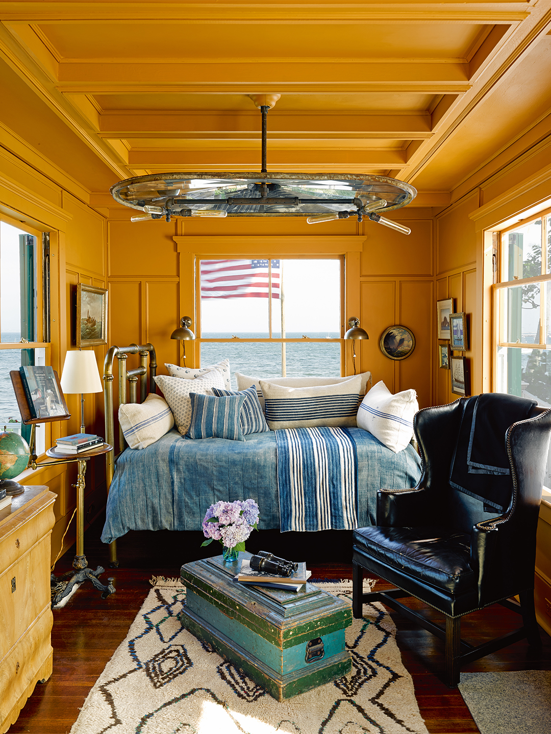 sunny yellow sleeping room with small blue bed
