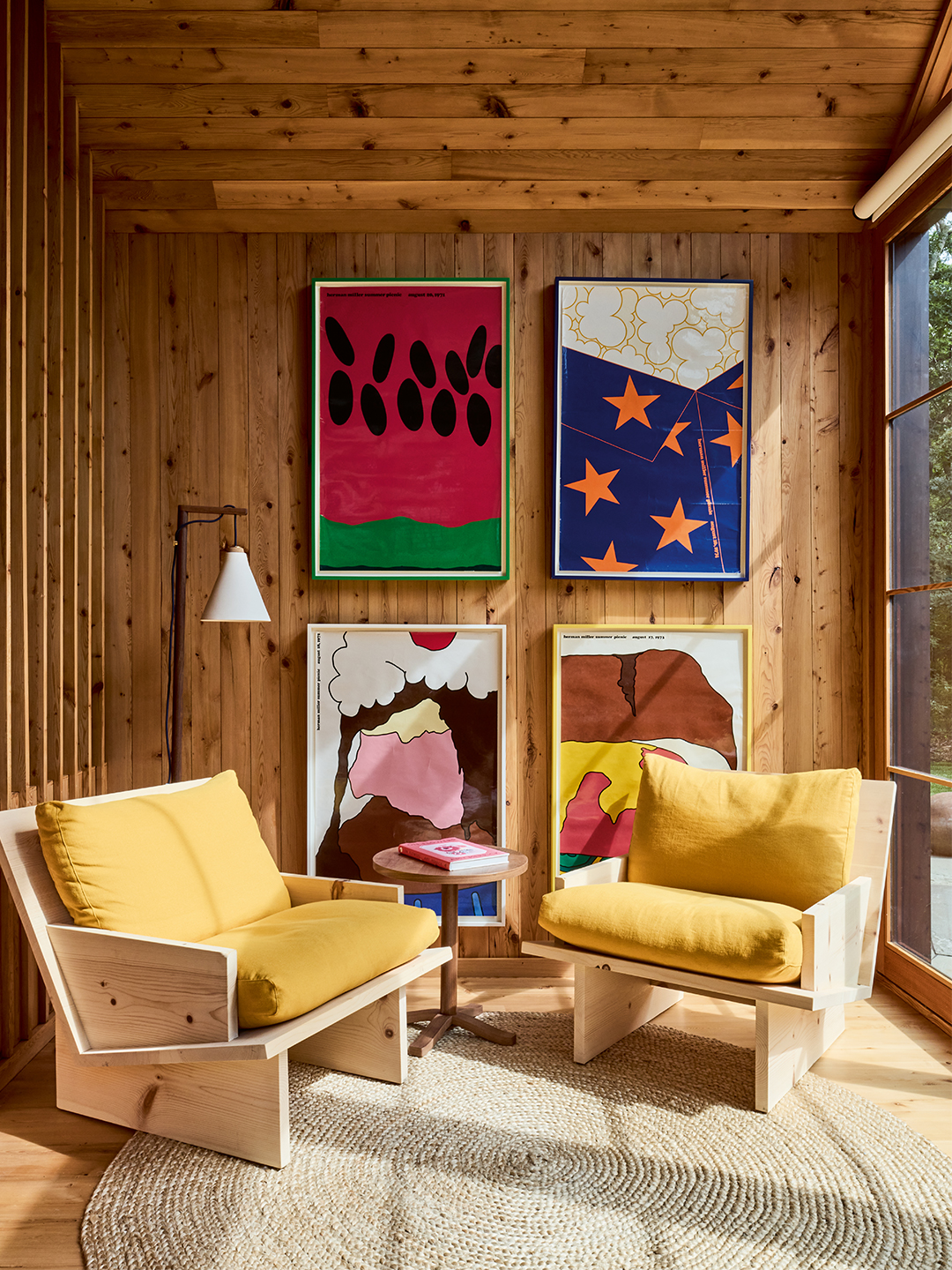 sunroom with two yellow chairs and colorful posters