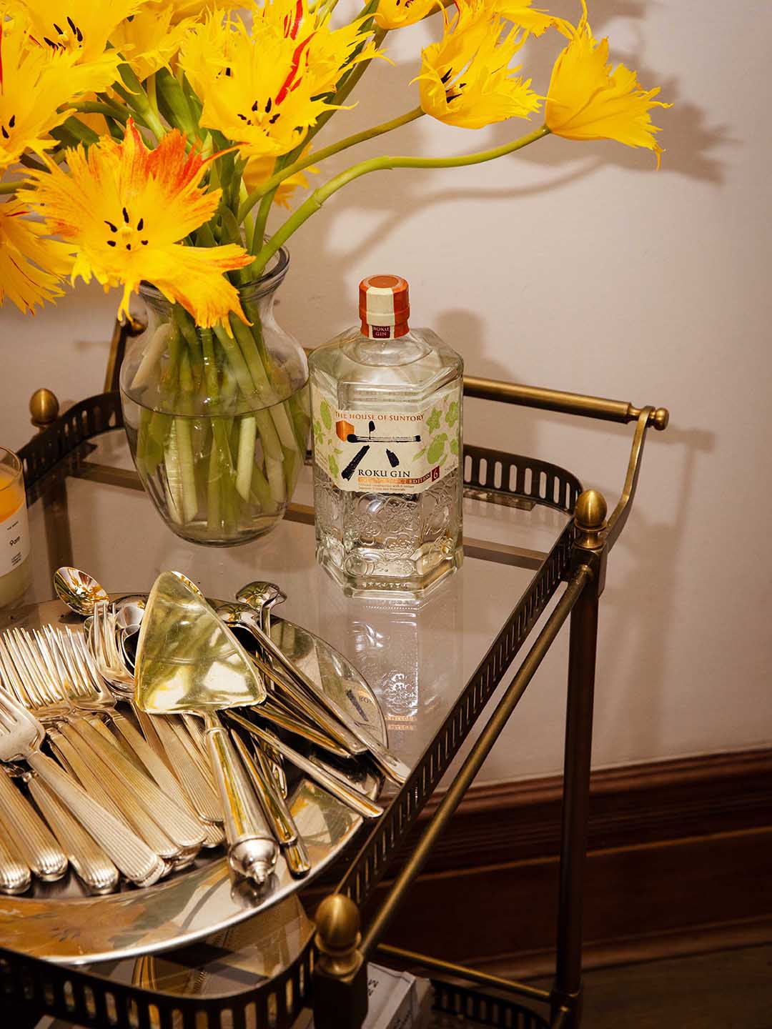 Bar cart with silverware and bottle of gin