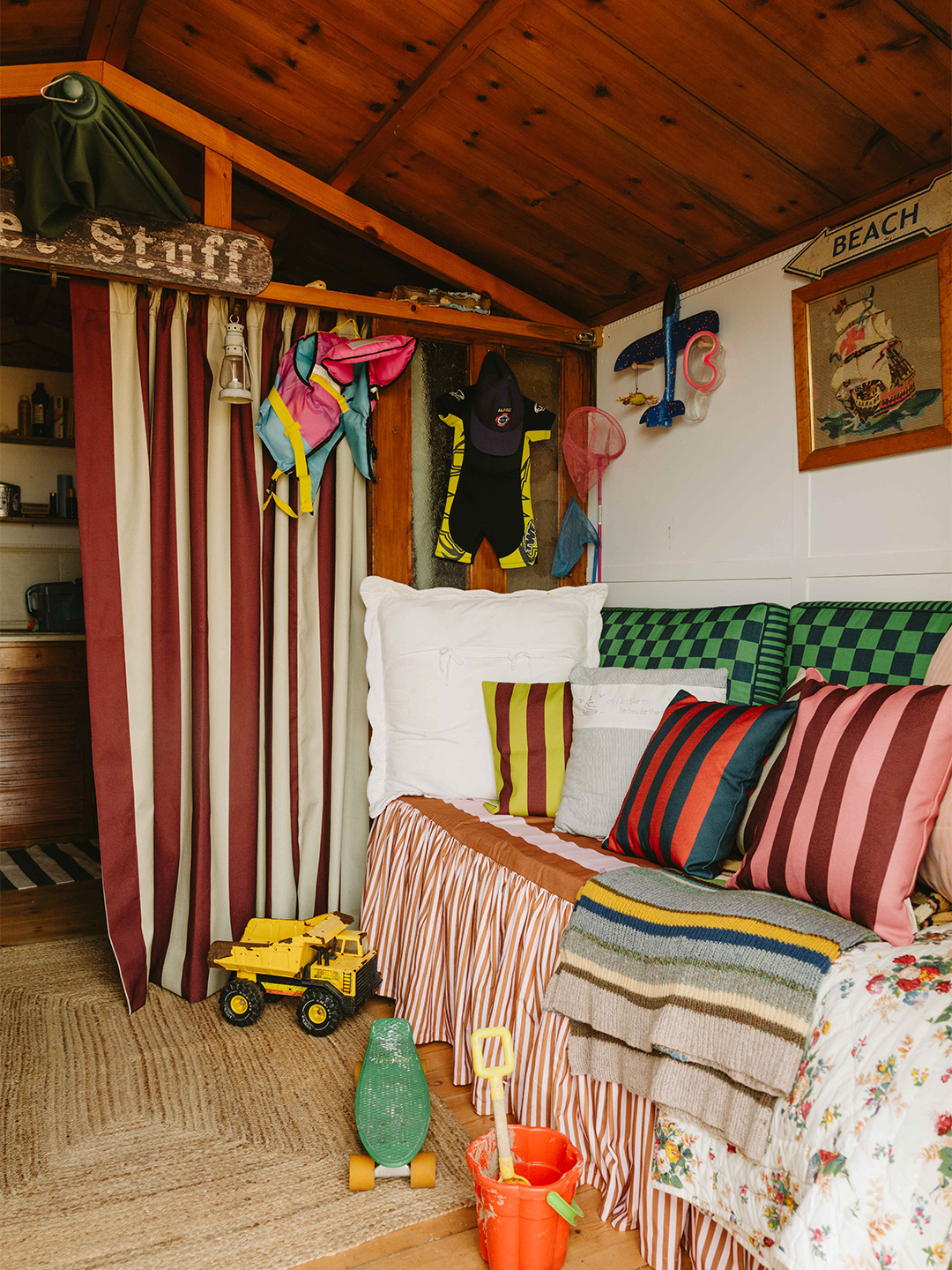 interior of colorful beach hut with lots of striped fabrics