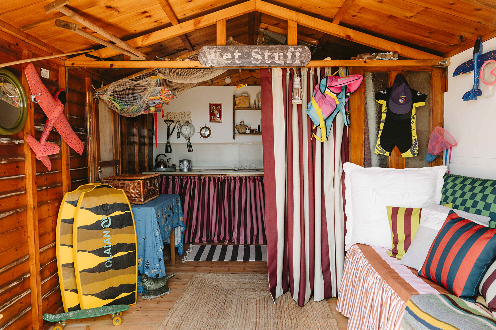 interior of colorful beach hut with lots of striped fabrics