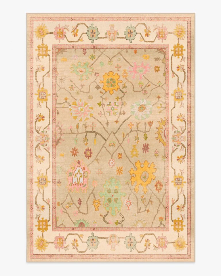 Cream rug with pink and peach flowers on white background.