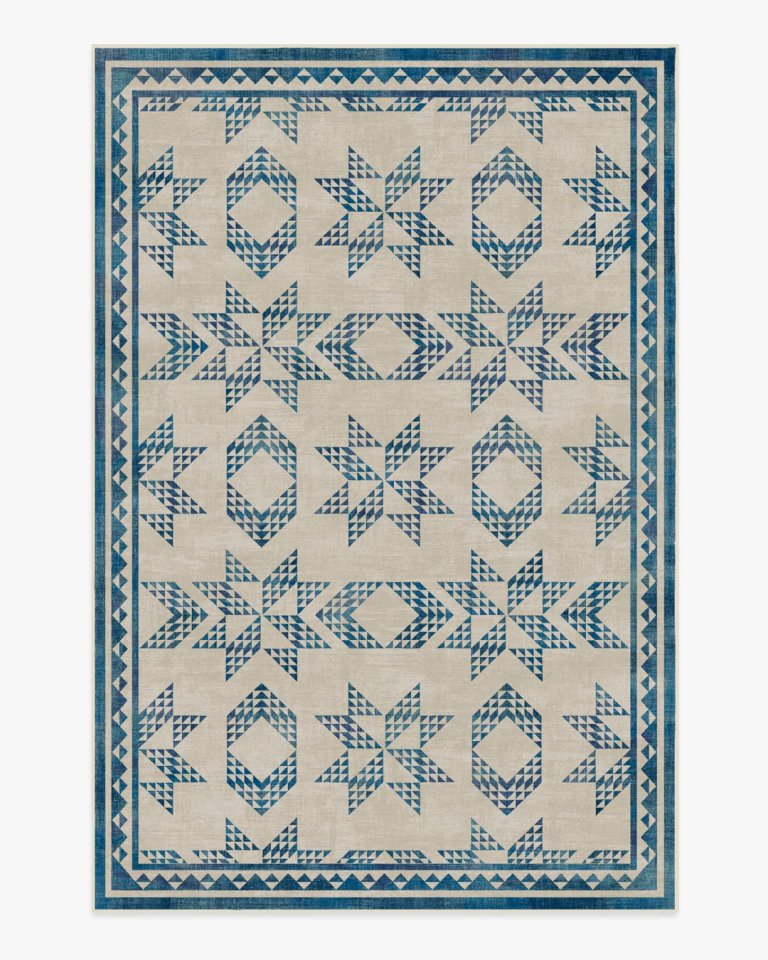 Blue and cream rug in a quilt-like pattern.