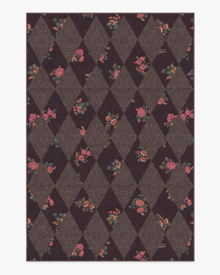Brown rug with harlequin pattern checkerboard and rose background.