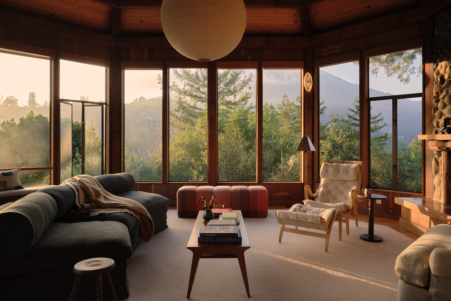 living room with windows looking out toward trees