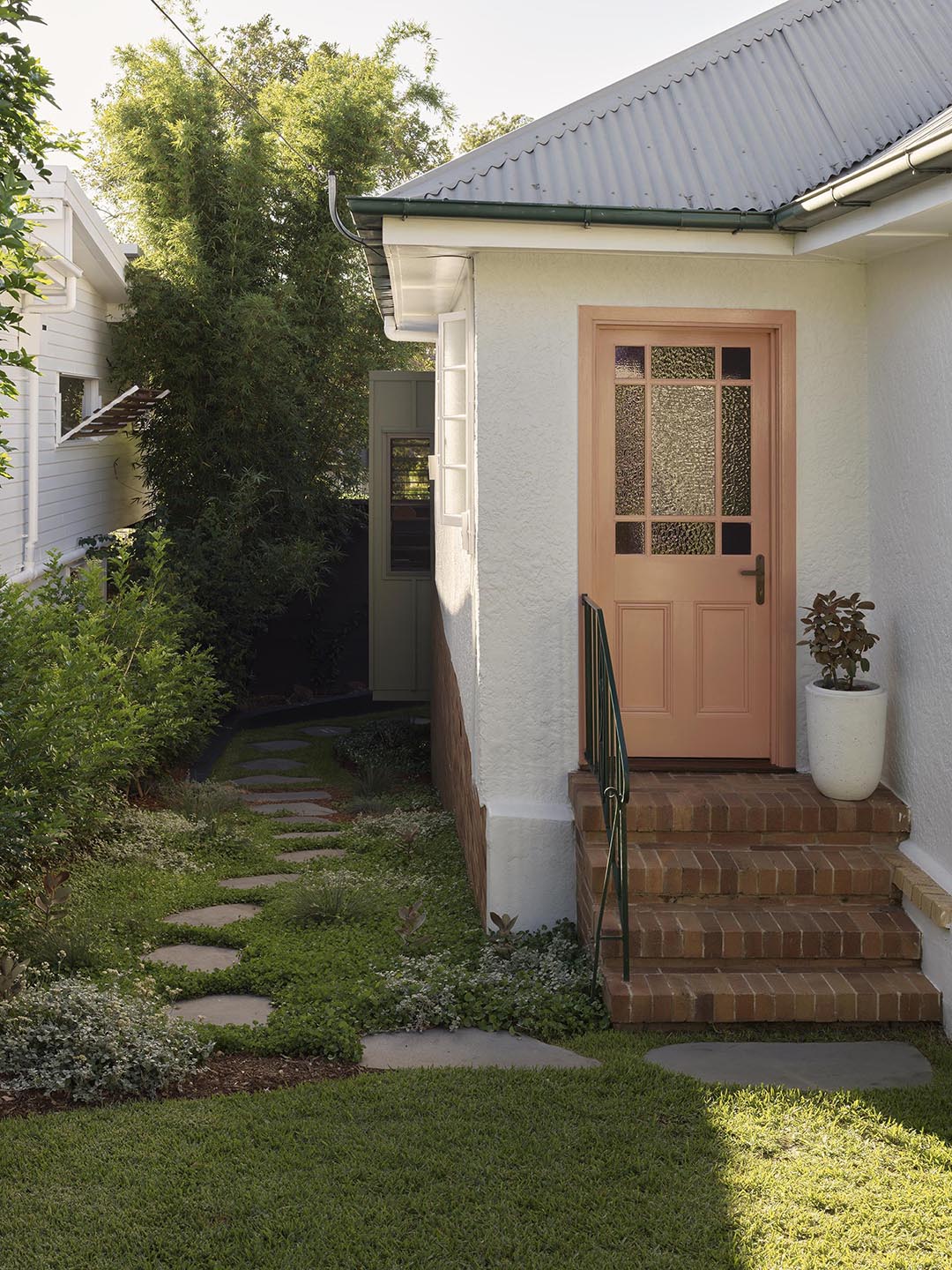 exterior of home with salmon colored door