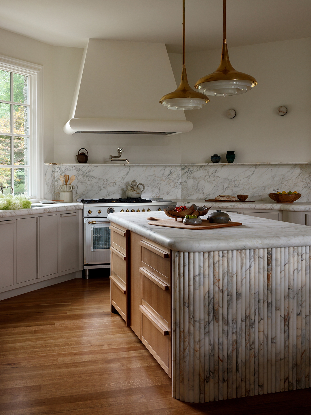 white kitchen with fluted marble island